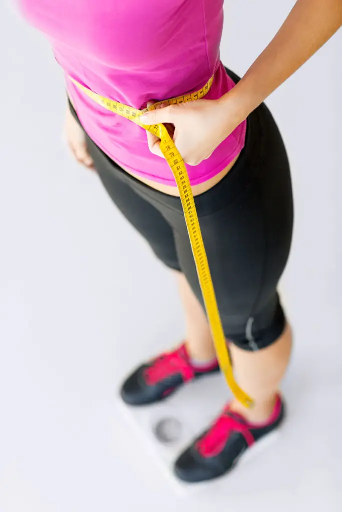 Measuring tape around stomach