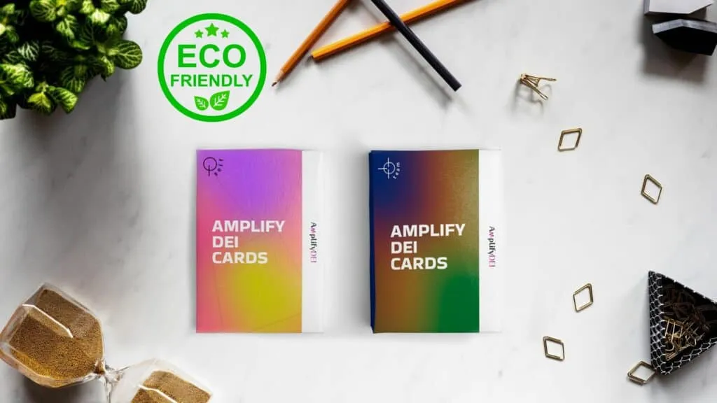 Eco-friendly Amplifying DEI cards on a desk with office supplies and plants