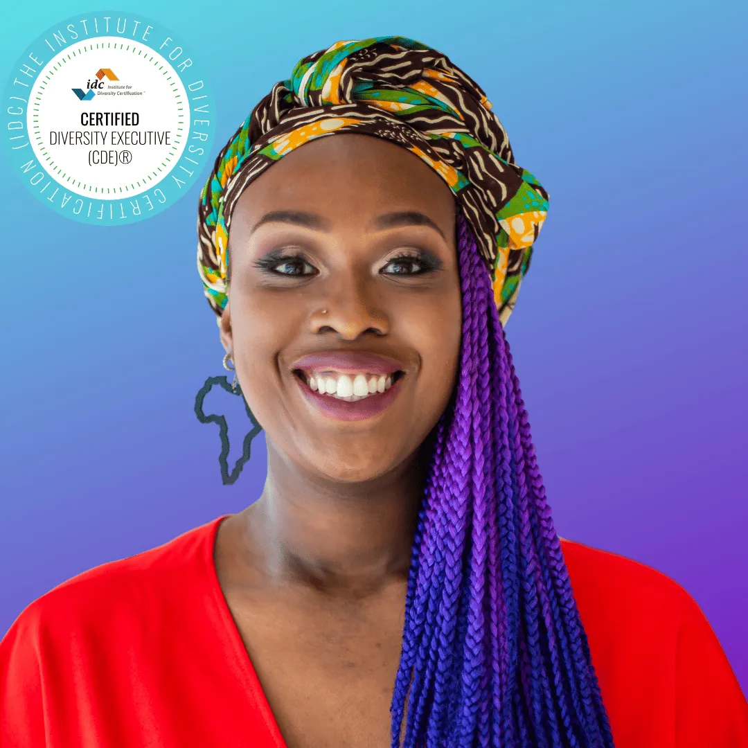 Smiling woman wearing a colorful headwrap and purple braids, with a Certified Diversity Executive badge