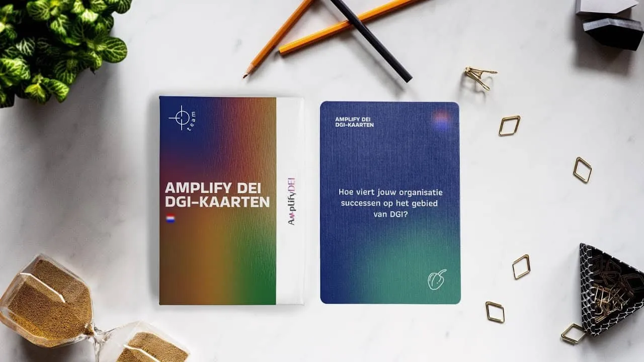 Amplify DEI cards on a table with stationery and a plant