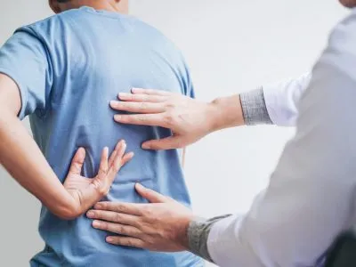 Doctor consulting with patient Back problems Physical therapy concept