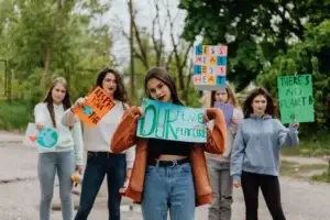 Young people holding Net Zero placards