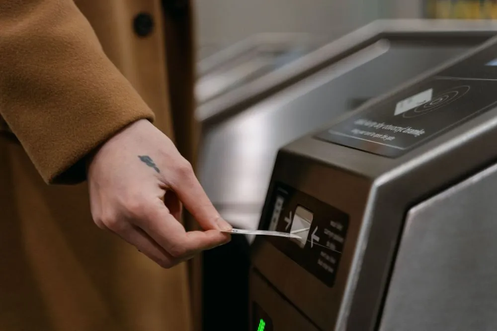 Sengkang West LRT Reopens Oct 4: What Riders Need to Know 4 Commuter tapping a card at fare gates before an off-peak train ride