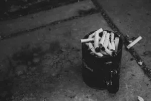 Cigarette butts on a pavement, a concern raised about Woodlands MRT smokers