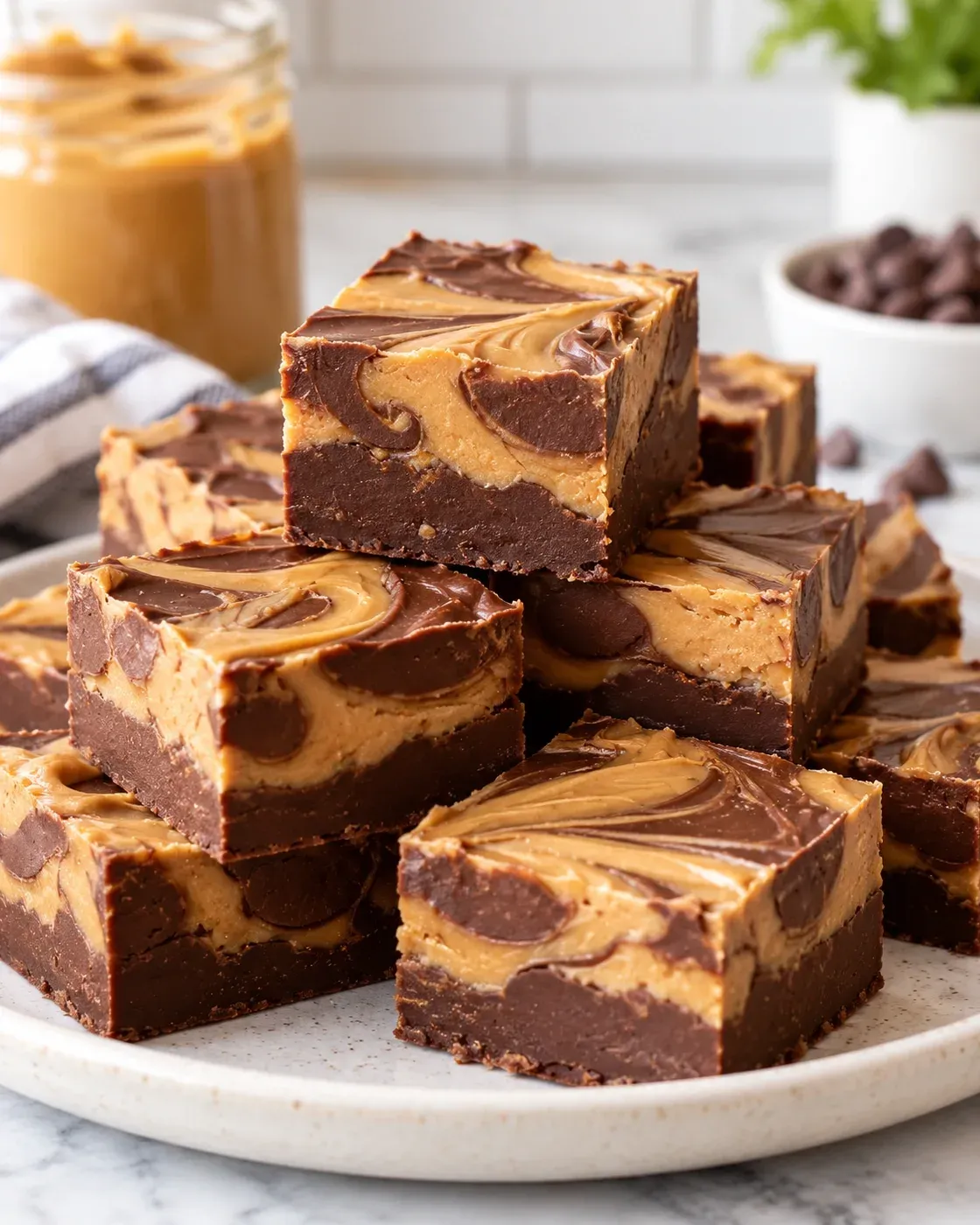 Peanut butter chocolate fudge squares with chocolate and peanut butter swirls.