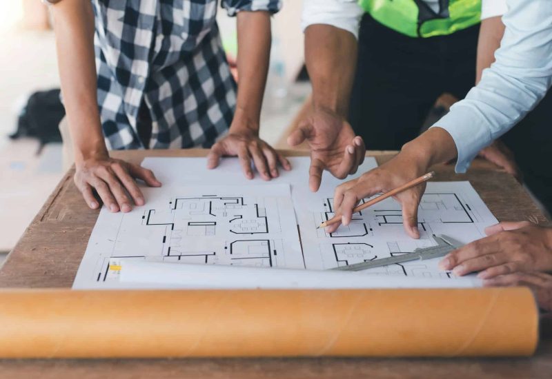 Engineer or architect plan meeting and draw model of office buildings working together