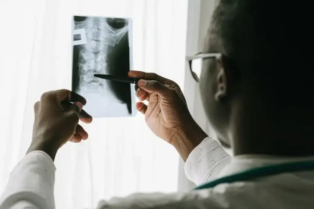 Minimally Invasive Spine Surgery in Plano, TX | Same-Week Consults 2 Pain specialist reviewing spine MRI scan with patient during Plano TX consultation