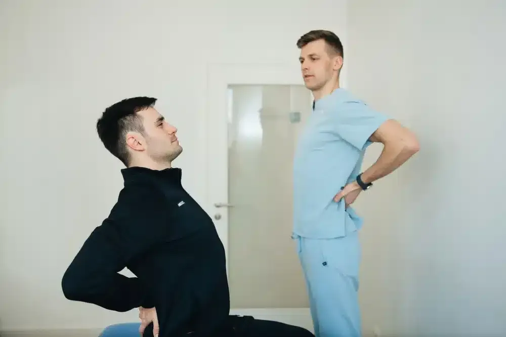 Physical Therapy for the Spine in Grand Prairie, TX | Non-Surgical Care 3 Patient performing guided stretching exercises during physical therapy for spine back pain