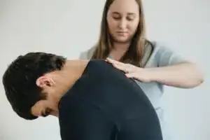 Physical therapist guiding a patient through spine physical therapy for back pain recovery
