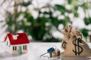 Selective focus of keys, house model and moneybags with dollar - Sprint Funding