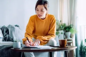 woman writing something on the paper