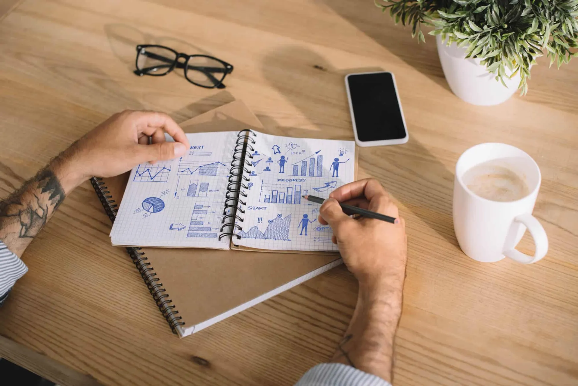 Man writing a business plan on notebook