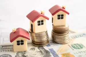 House model with stack of coin money, home loan, saving plan, installment payment finance and banking concept.