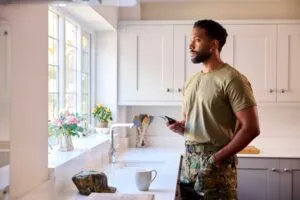 soldier in his uniform holding a phone