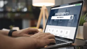 A man's hands typing on a laptop