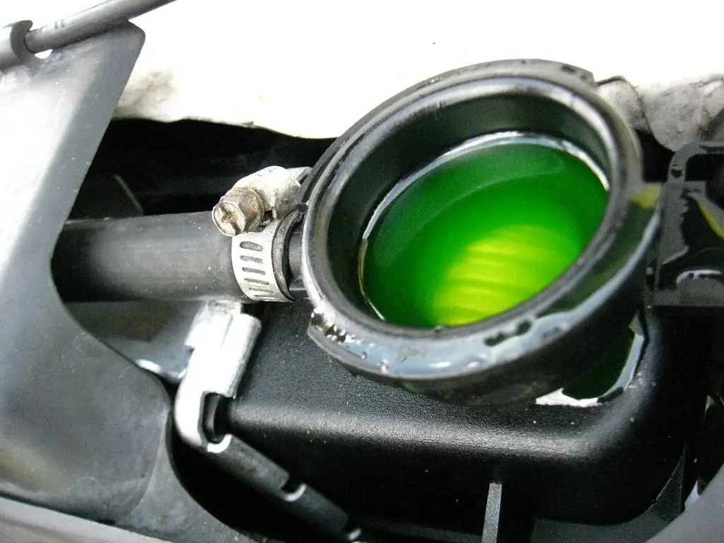 Open radiator filler neck showing green coolant, a place to check when tracking down a coolant leak