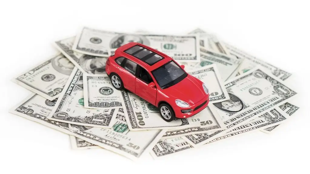 Toy car sitting on a pile of dollar bills, illustrating car loan negative equity and gap insurance