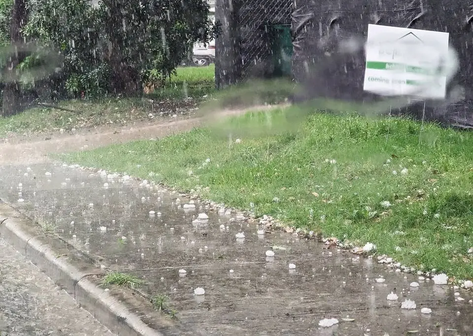 Hailstones on the ground after a storm that can dent cars