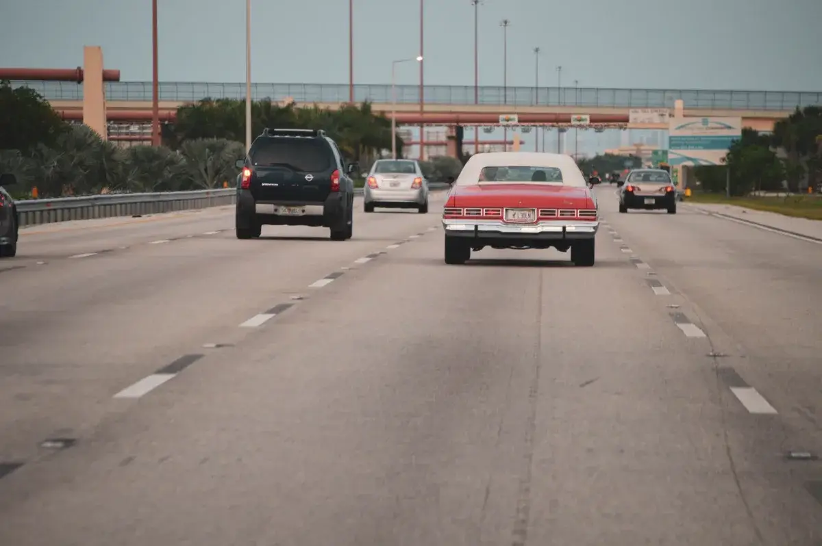 Highway traffic scene with classic car in Miami, Florida, showcasing urban travel atmosphere