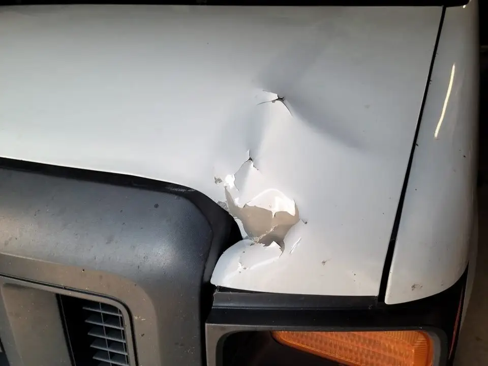 Dent in a car hood that paintless dent repair may be able to fix