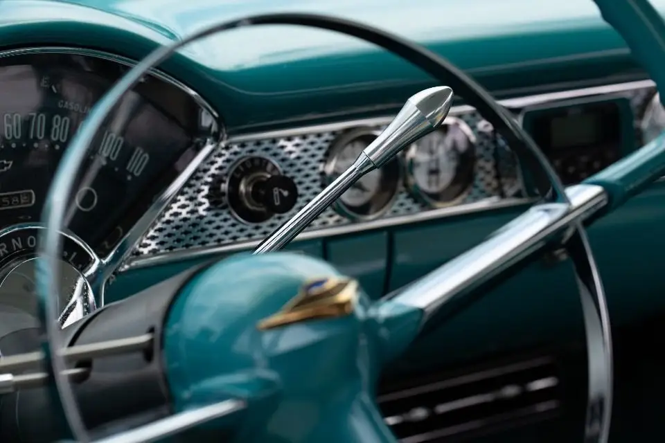 Close-up of a car steering wheel and dashboard; a failing power steering pump makes this wheel hard to turn