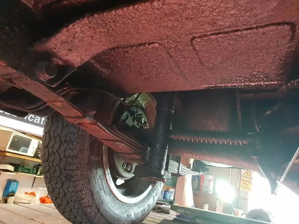 Underside of a vehicle showing the suspension near the wheel, where sway bar links connect the bar to the suspension