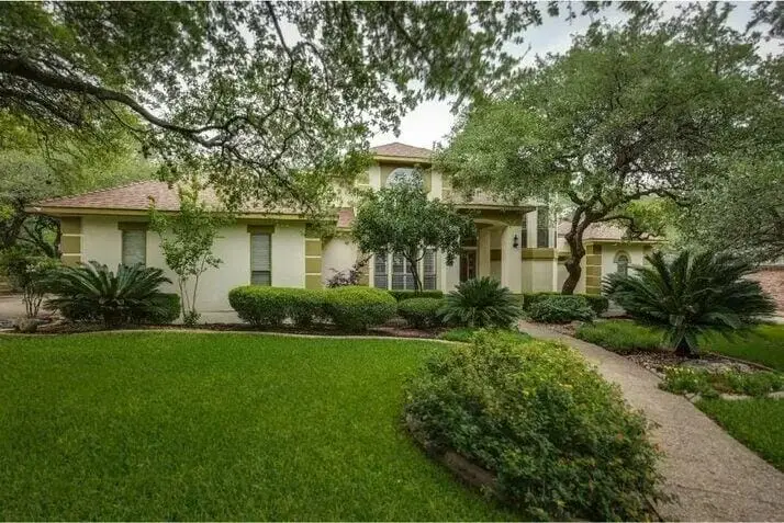 Texas home with landscaped yard and trees