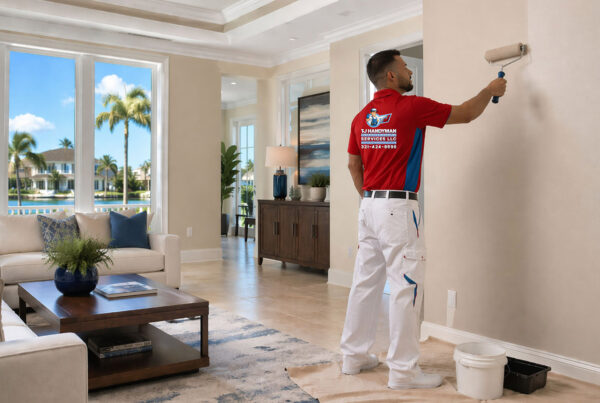 What is the best time of year to paint your house interior in Orlando by TJ Handyman Services, a professional painter applying interior wall paint in a bright Orlando home.