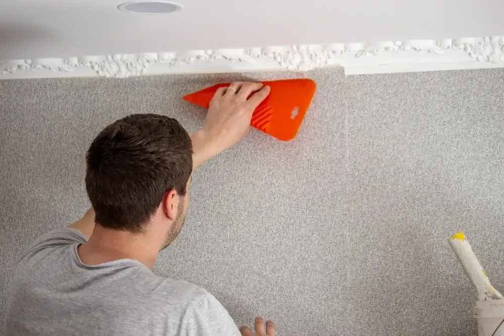 a-man-glues-wallpaper-repairs-the-hous