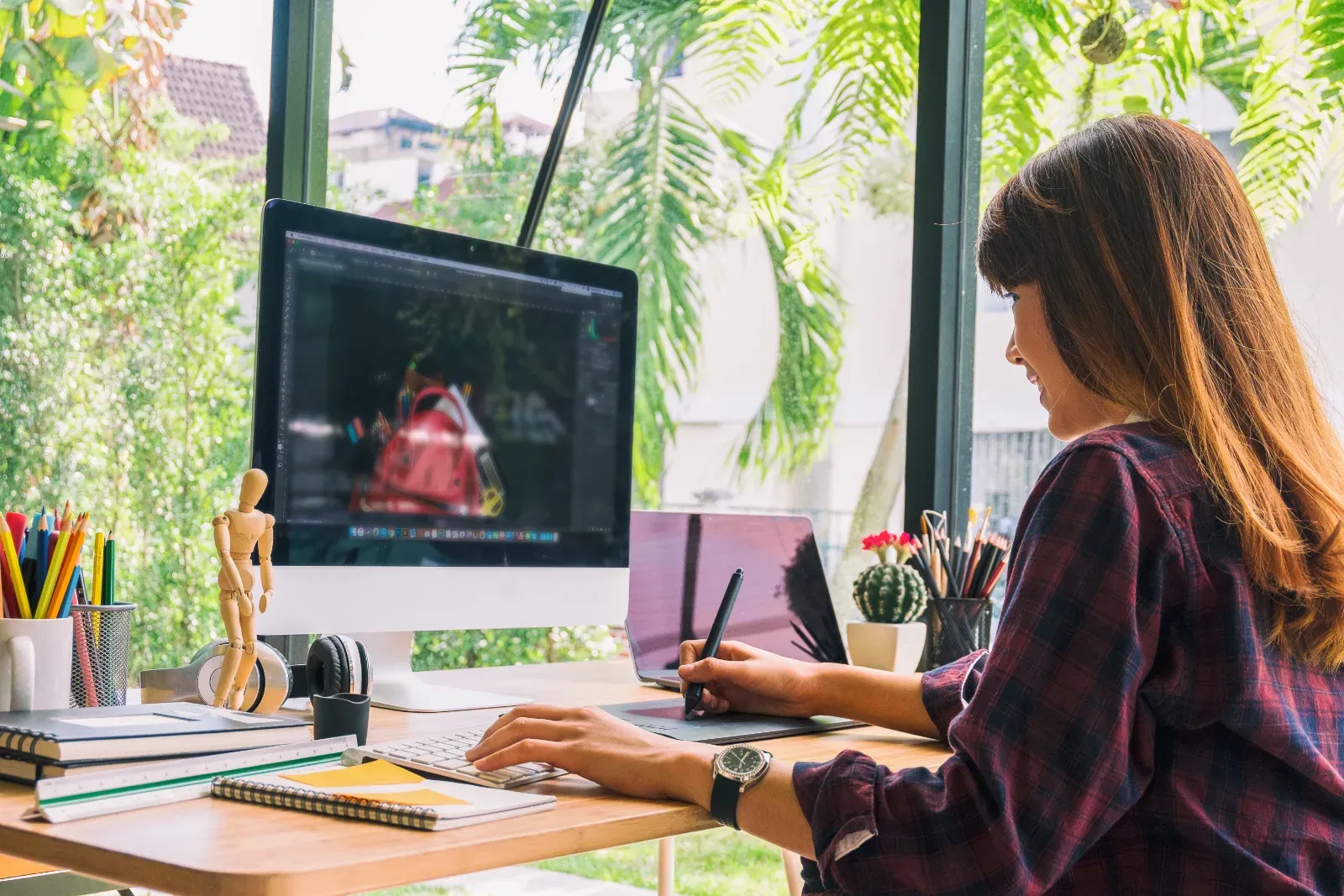 Graphic designer working on brand and print collateral design in a studio