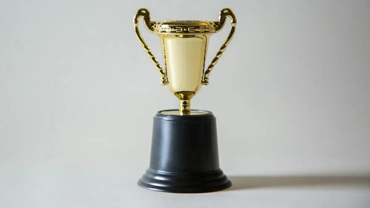 Small gold trophy with black base against a plain gray background