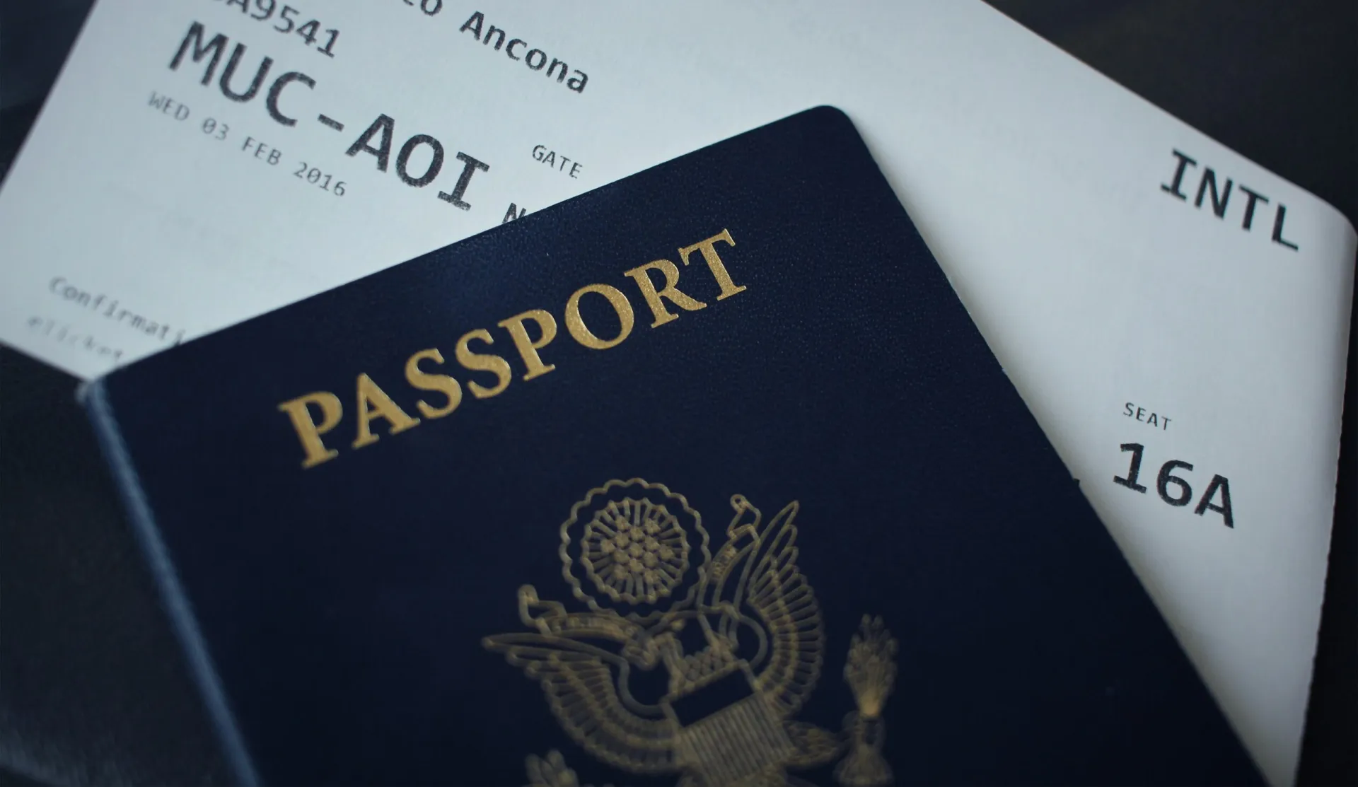 Passport on airplane ticket representing international travel document preparation