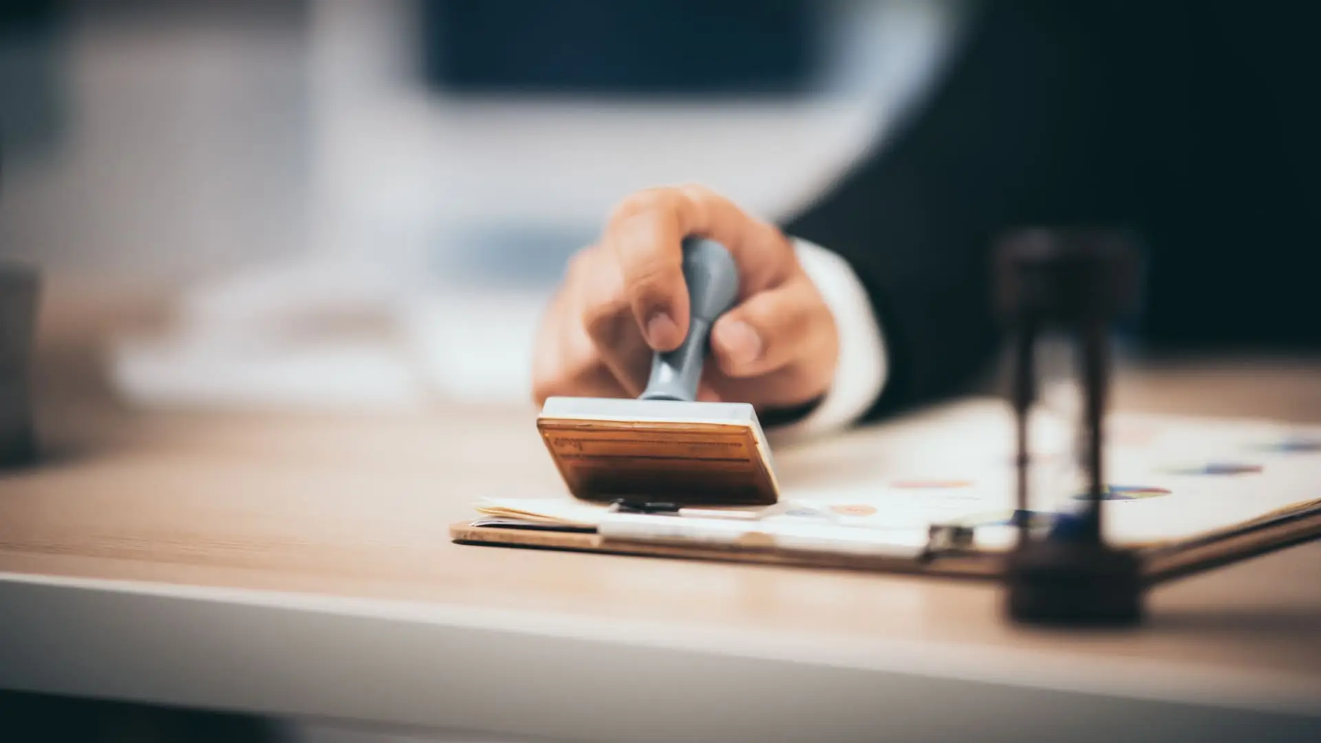 91 Hand stamping an official document on a desk