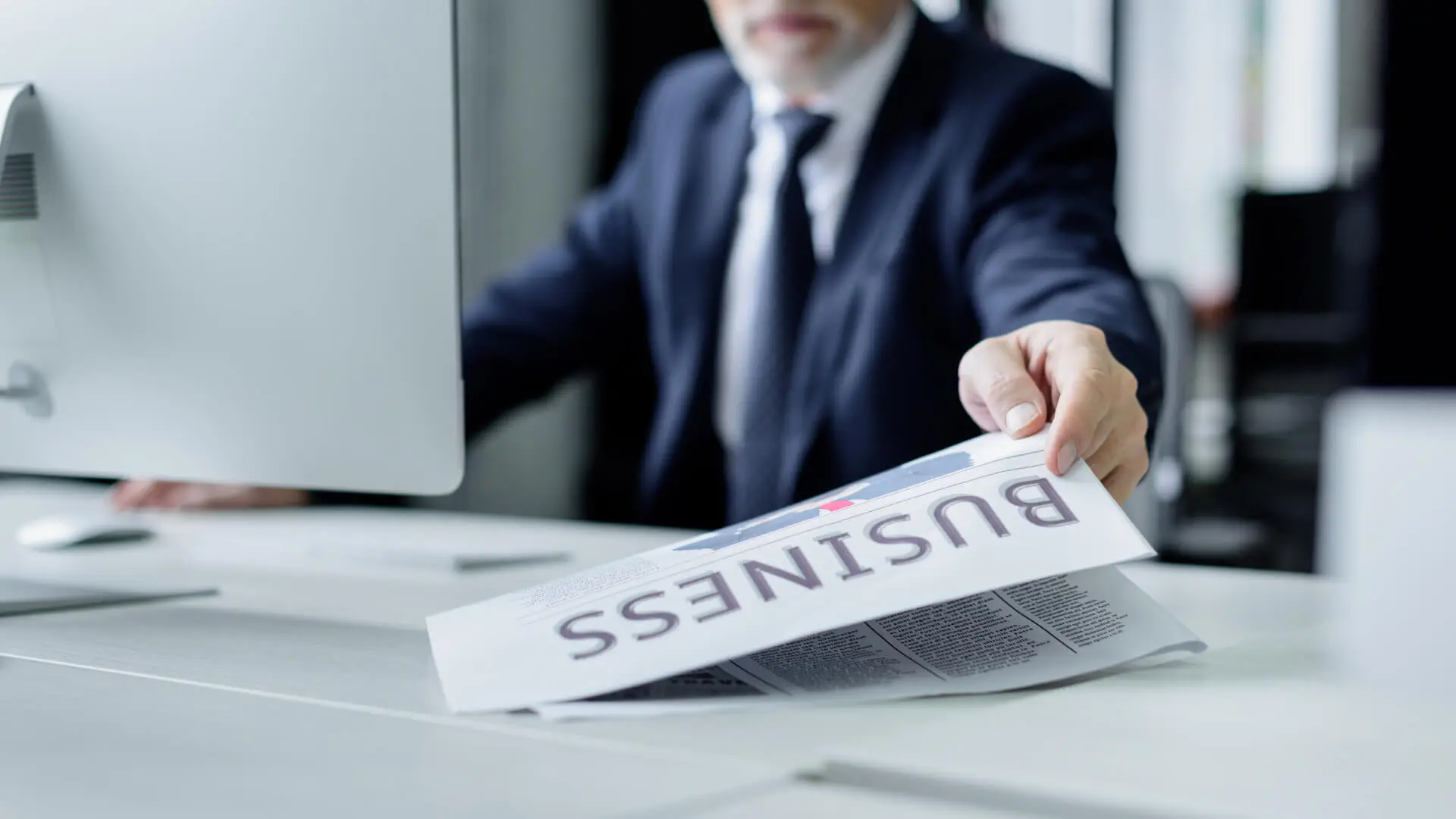 79 Businessman reviewing business documents at his desk.