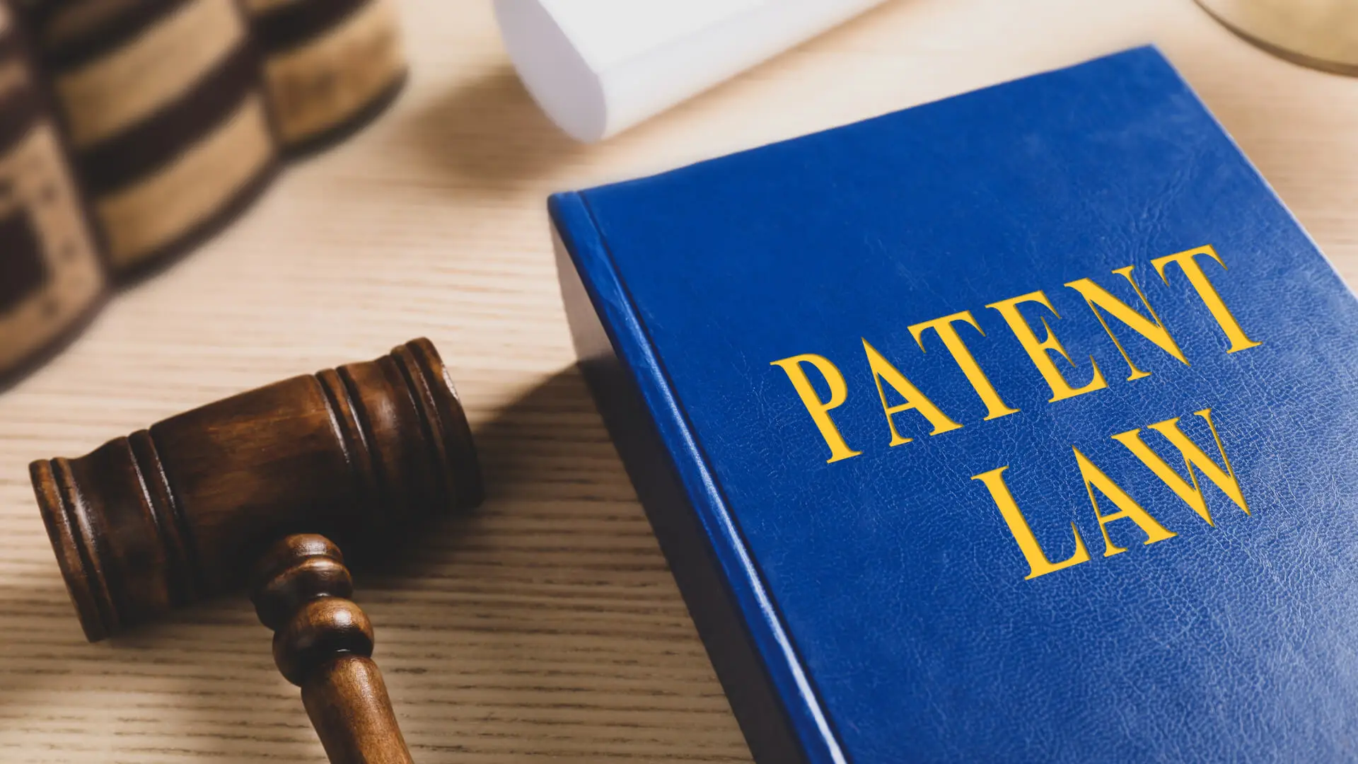 Patent law book with a judge’s gavel.