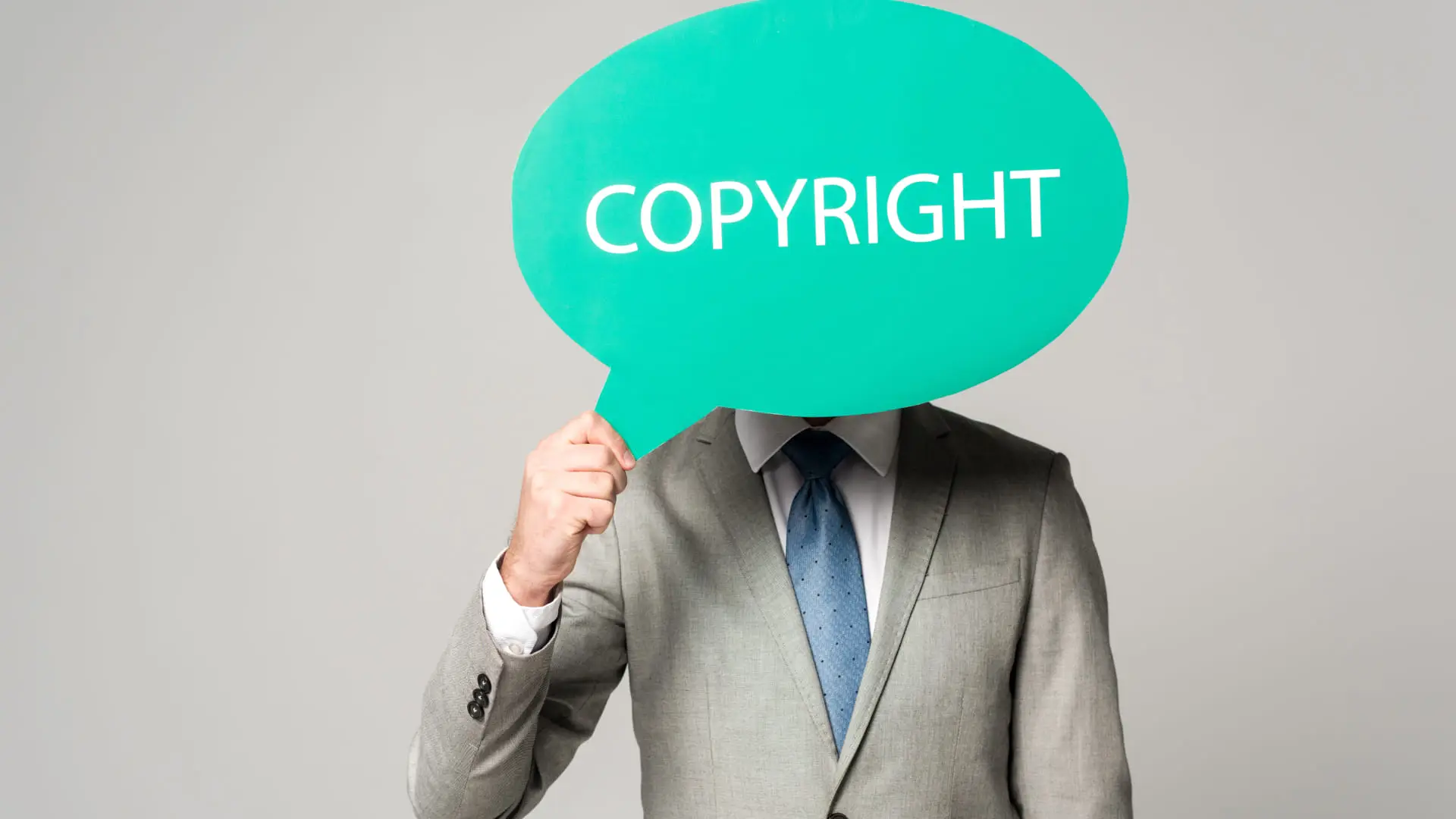 83 (1) (1) Businessman holding a sign with the word copyright