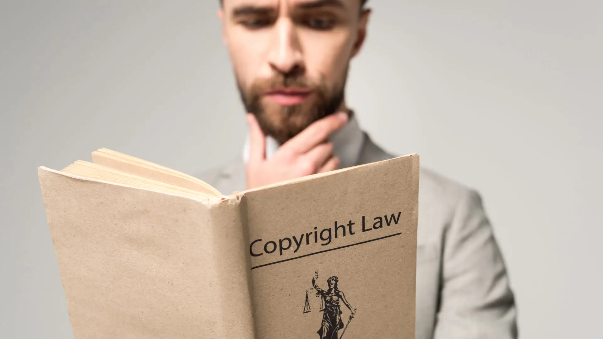 Man reading a book about copyright law.