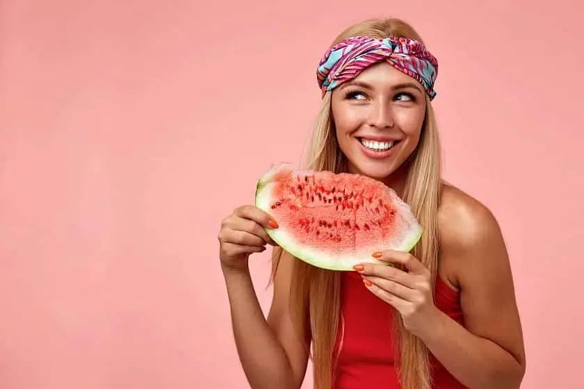 portrait-blonde-happy-female-with-long-hair-holding-piece-watermelon-looking-aside-smiling-broadly-posing-Superfoods With Low Calories Why We Love Superfood (And You Should, Too)