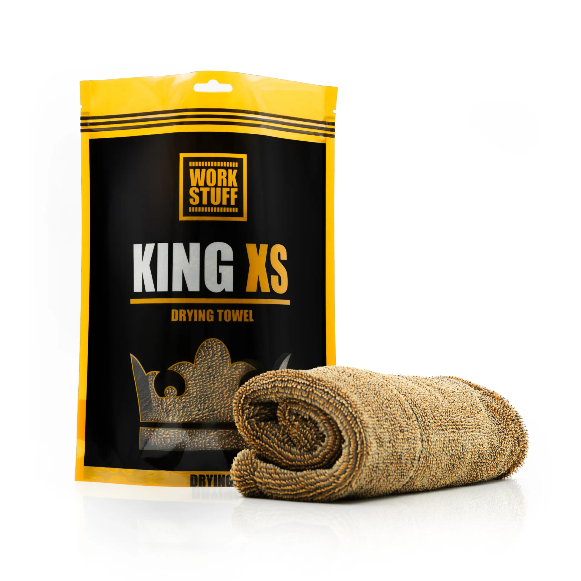 A golden brown microfiber towel, rolled up, beside its black and yellow Work Stuff King XS Drying Towel packaging on white.