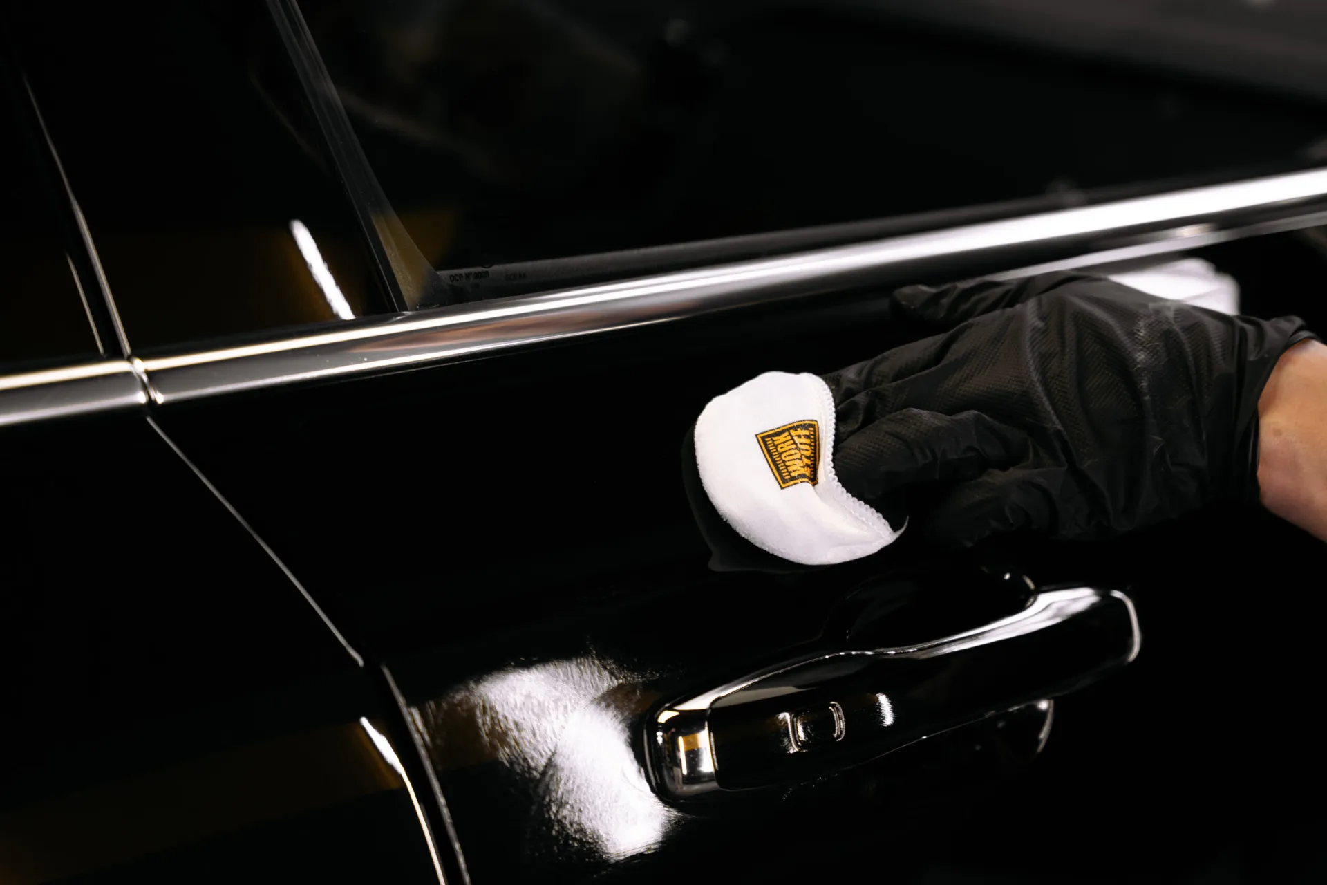 Applying ceramic coating to black car paint in controlled passes