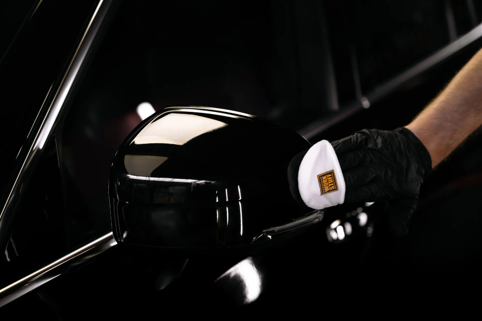 Microfiber ceramic coating applicator used on a painted car mirror