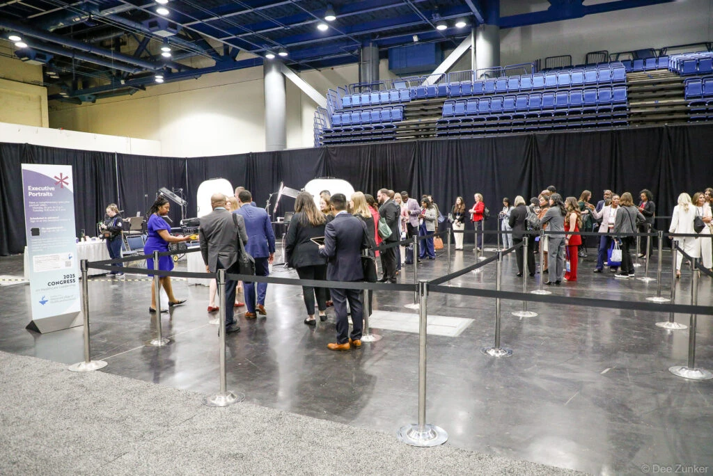 Professionals queue at an Executive Portraits booth during the ACHE Congress event, photographed by Dee Zunker Photography at a Houston convention venue.