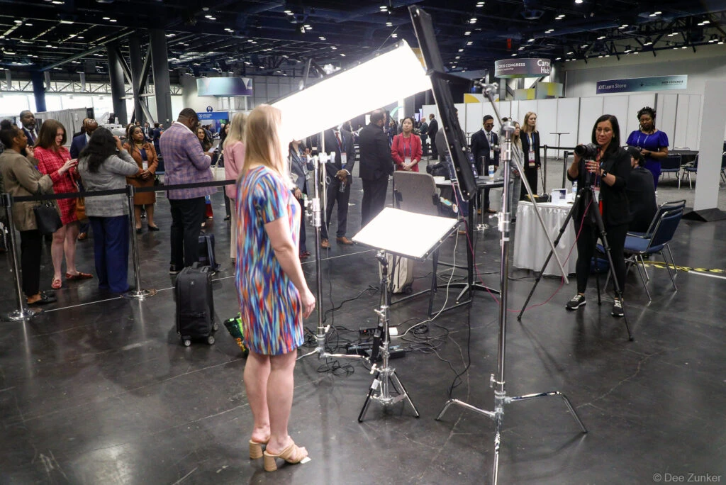 Giving Direction with lines behind at dual headshot station at george R Brown Convention Center in downtown Housotn, TX