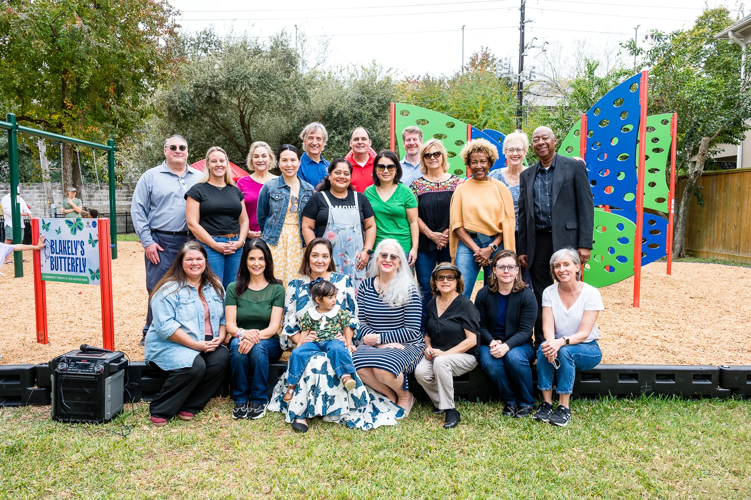 Lindsey McLeod McCrory standing with the Bellaire Patrons of the Parks and City Representatives in front of the newly dedicated Blakely's Butterfly play structure at Joe Gaither Park in Bellaire, TX.
