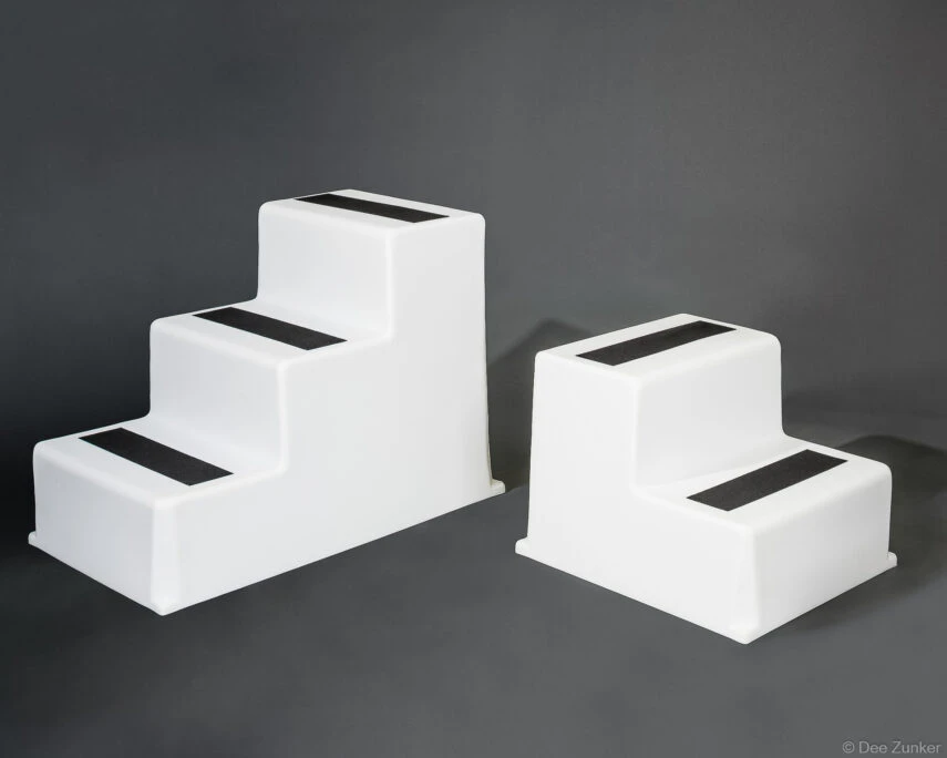 Two white polyethylene marine step boxes with black grip strips, professional product photography on gray background, Houston TX.