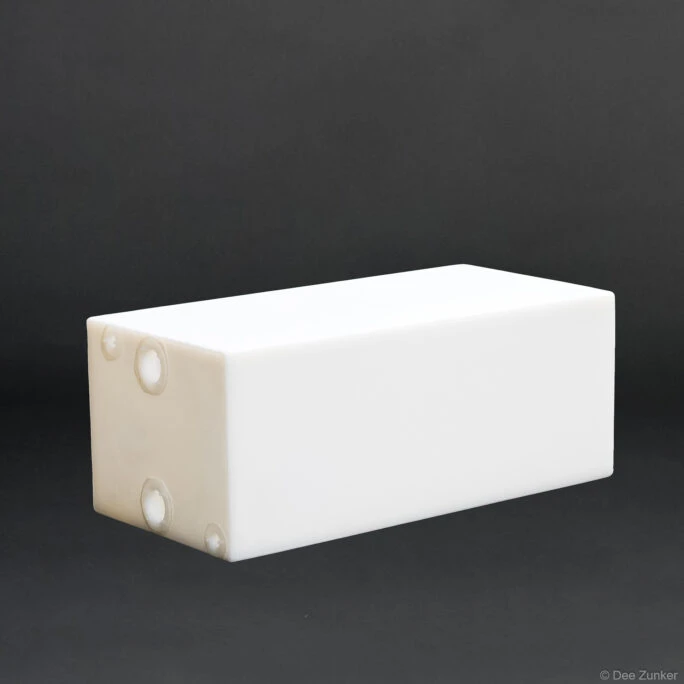 White rectangular polyethylene boat flotation box with molded fittings, shot against gray background for Houston commercial product photography.