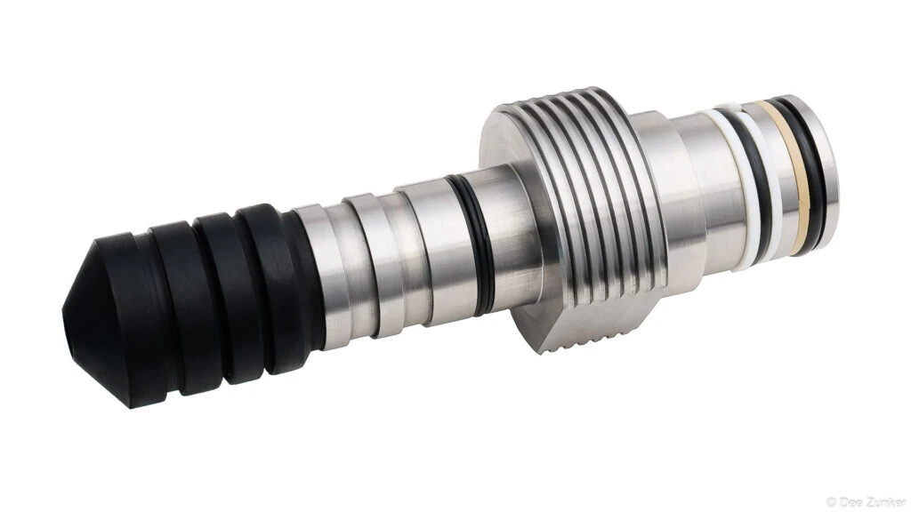 Stainless steel industrial drilling tool with rubber tip and O-ring seals, product photography on white background, Houston TX.