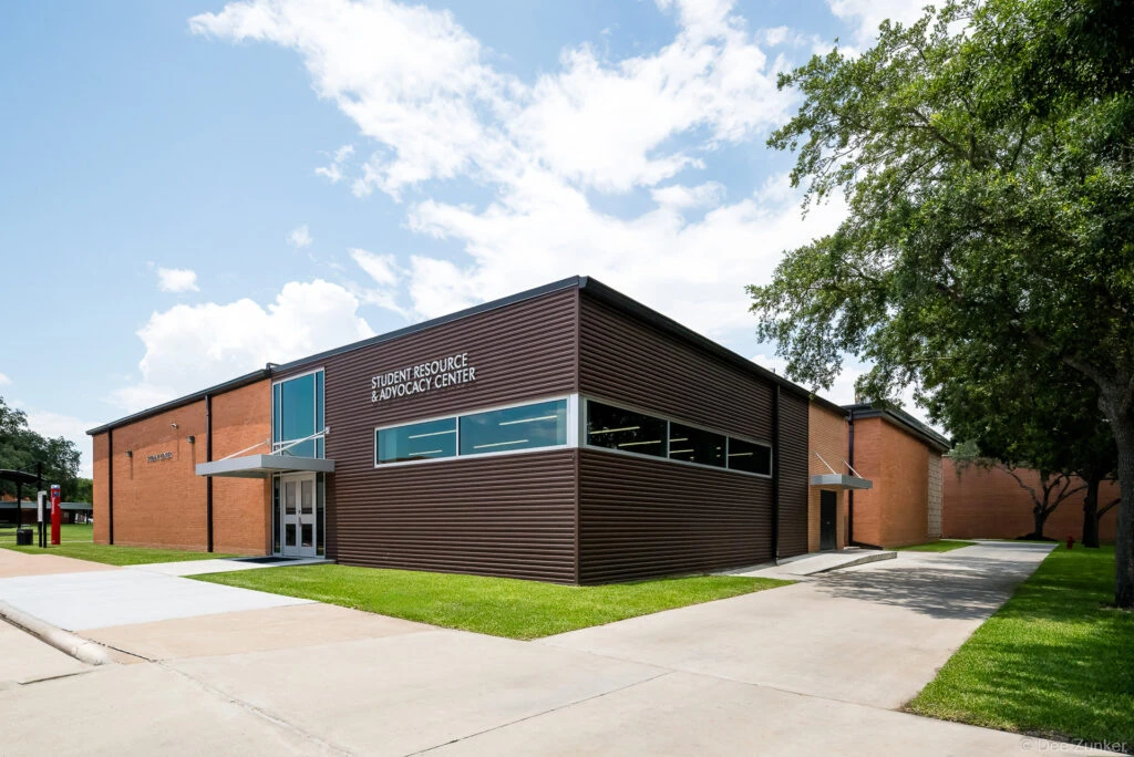 Exterior view of the Lee College Student Resource and Advocacy Center in Baytown TX featuring modern corrugated metal cladding and brick facade