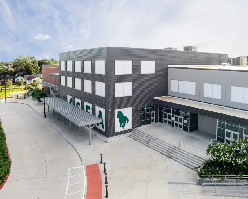 Aerial exterior view of Stephen F. Austin High School modern addition with green mustang mascot logo Houston Texas