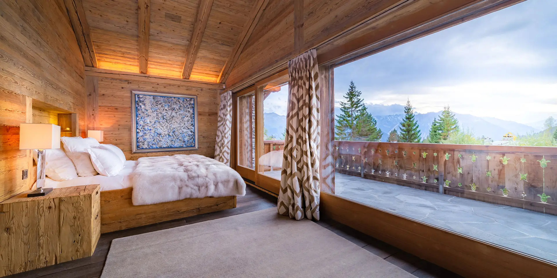 Luxury GuestLee Geneva villa bedroom with wood accents, plush bed, fur blanket, Alps view balcony, modern d&eacute;cor, warm lighting. | GuestLee luxury rental Switzerland